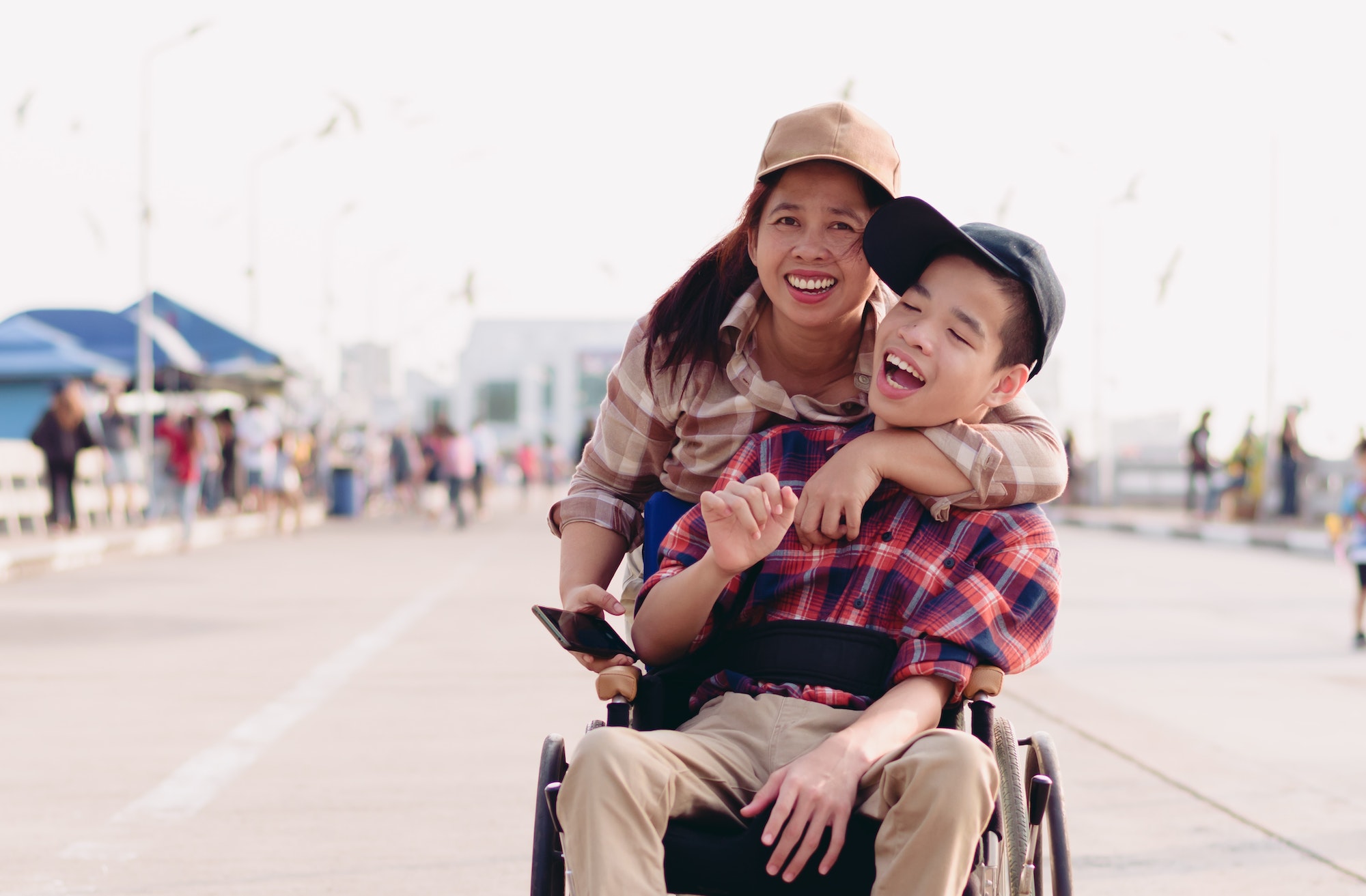Asian Disabled child on wheelchair and mother in the outdoors nature